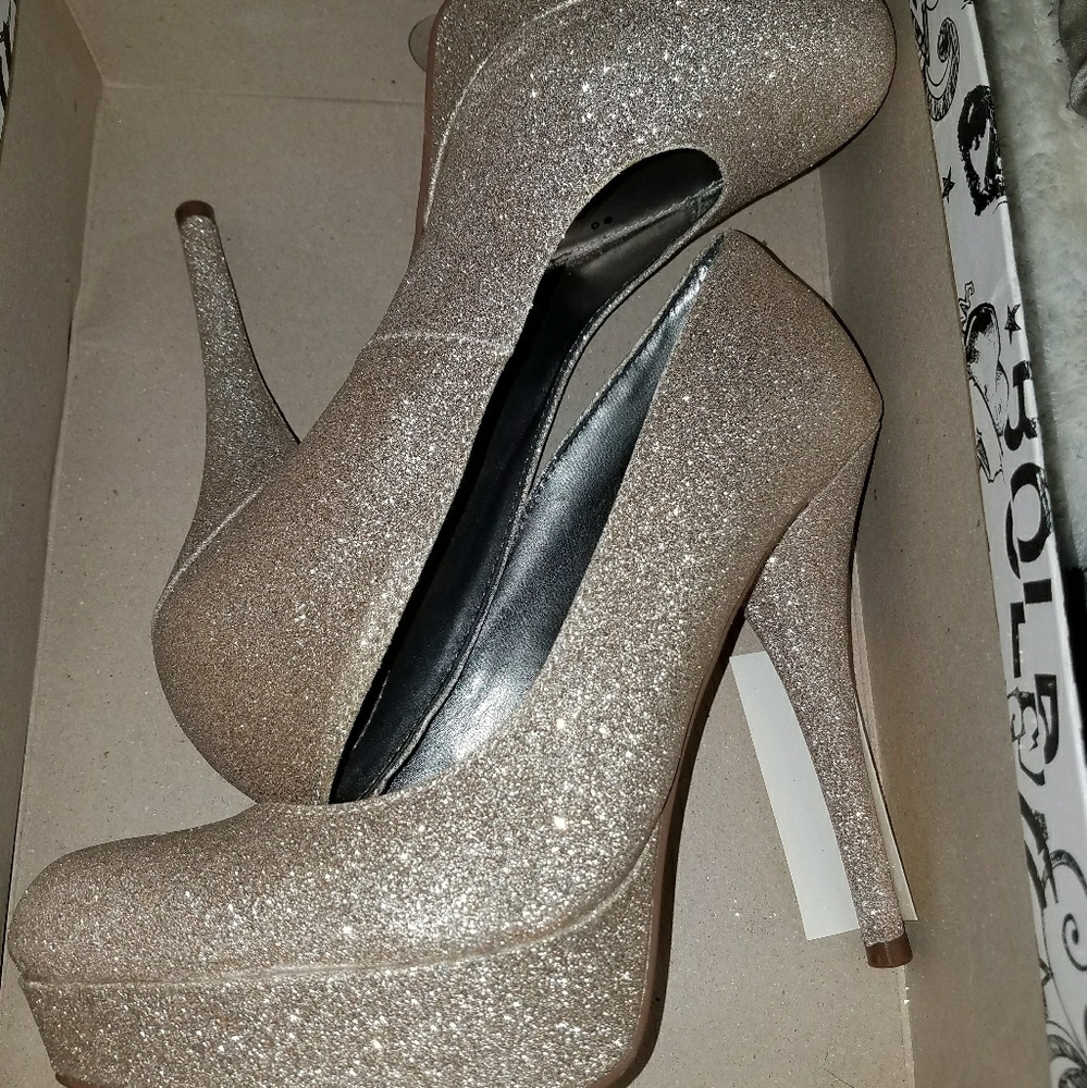 Gold high heeled shoes